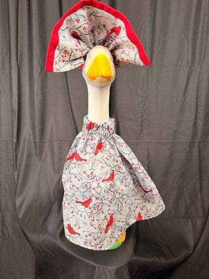 Goose statue wearing cardinal and berry print dress with wide cardinal print hat – front view